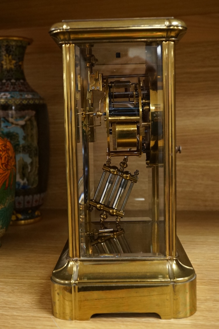 A four glass and brass mantel clock, 25cm high, 17cm wide.